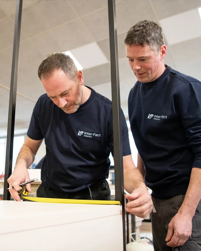 Inter Fact craftsmen measuring an interior element